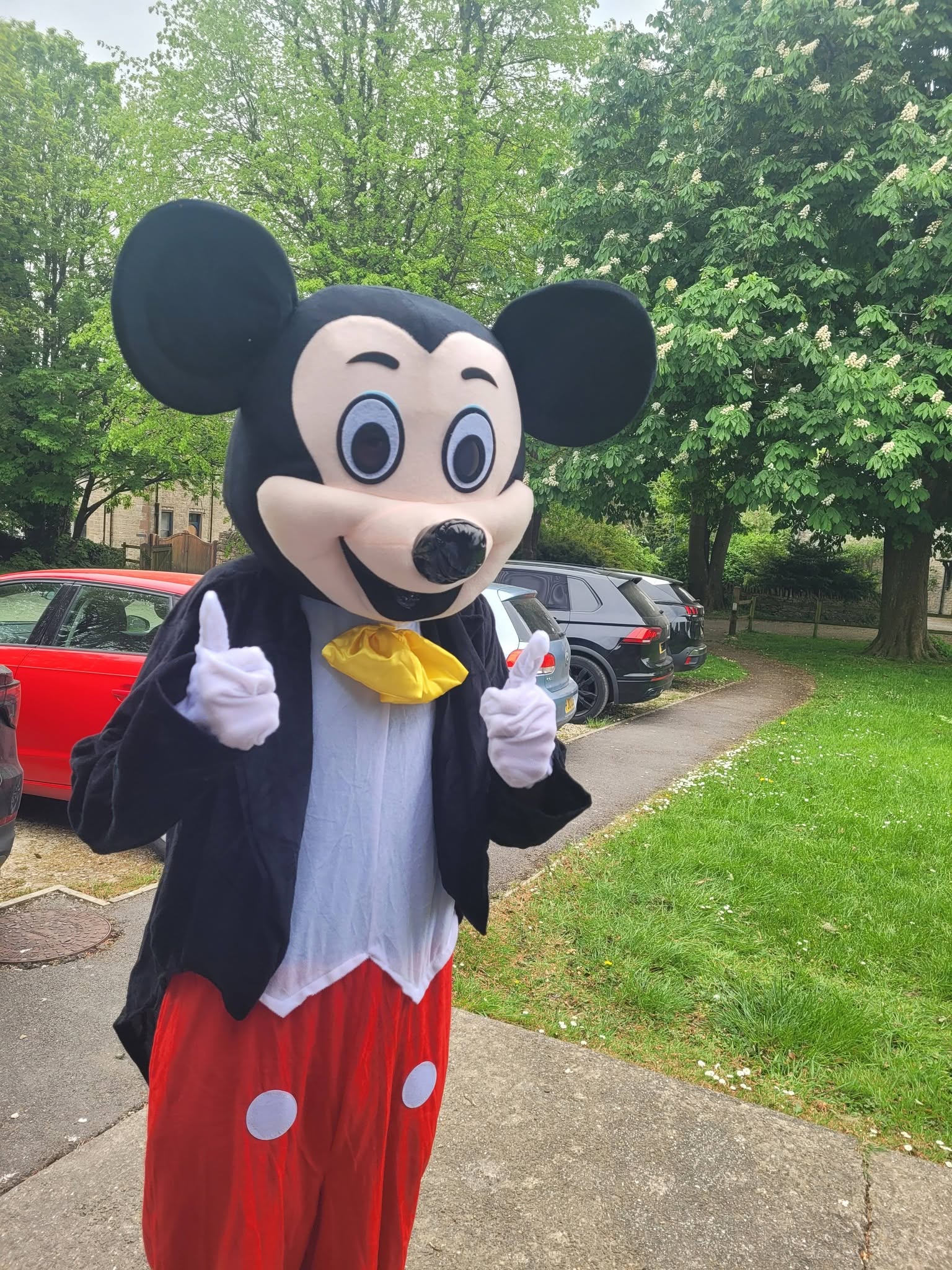 Mickey Mouse character giving a thumbs up