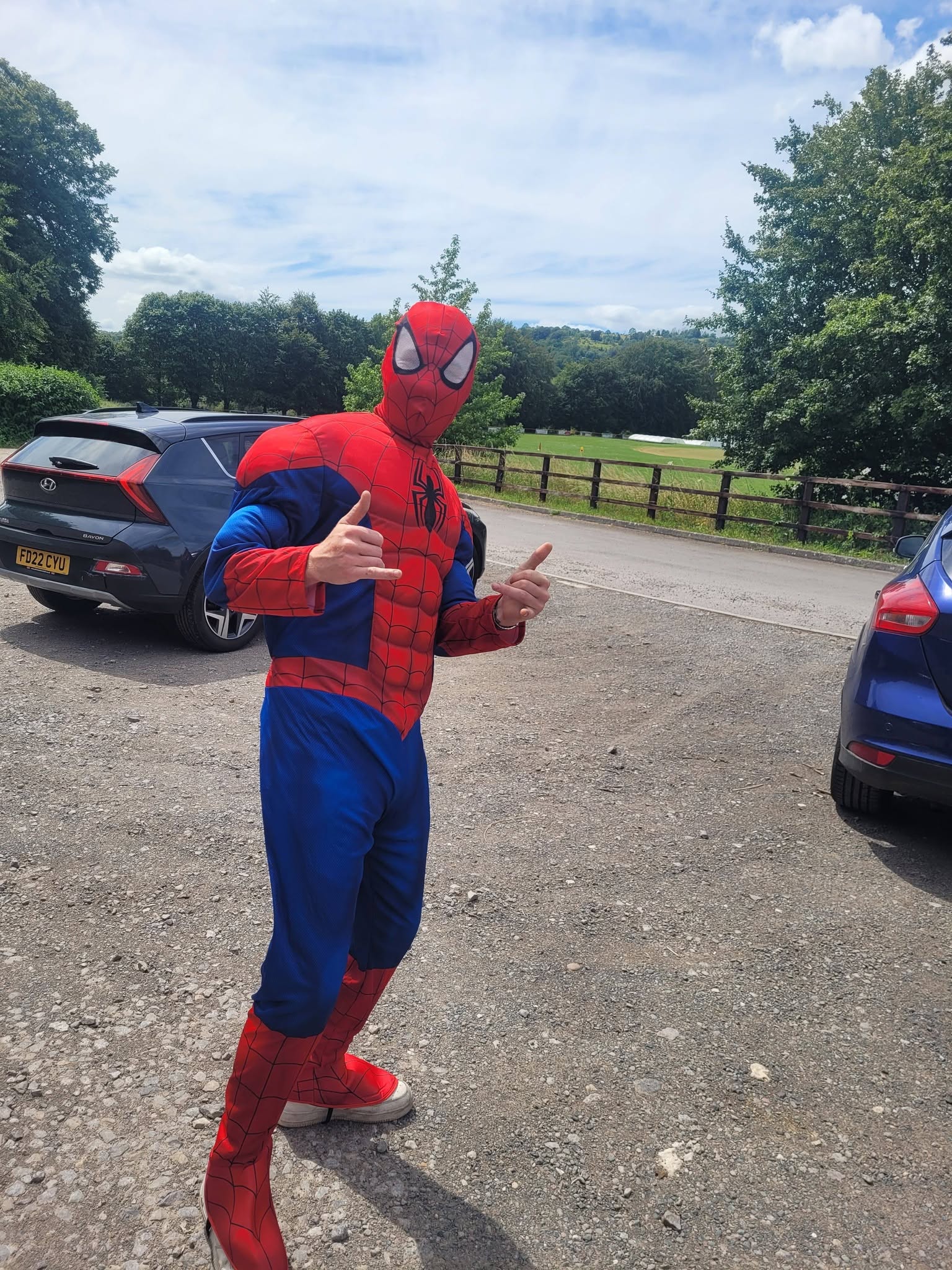 Person in a Spider-Man costume at an outdoor event