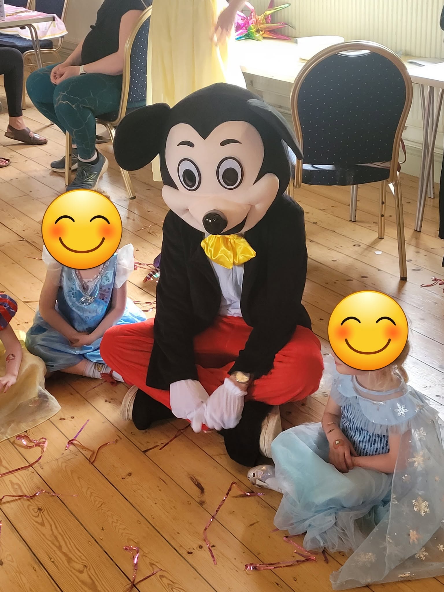 Mickey Mouse character interacting with children