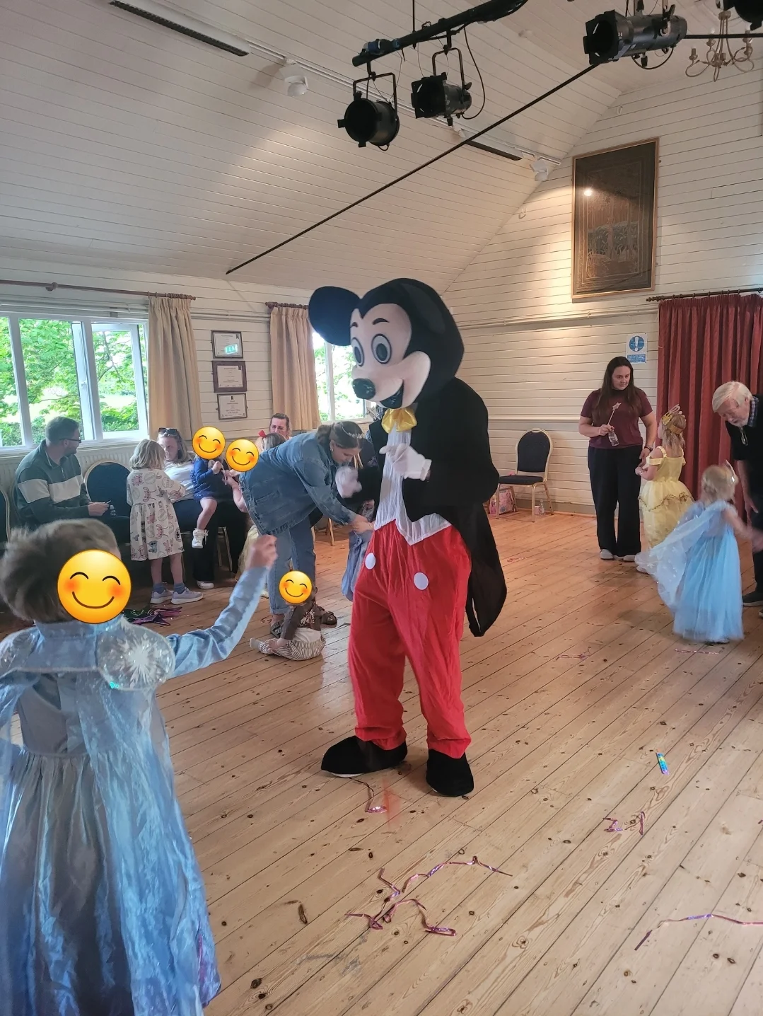 Mickey Mouse character interacting with children at a party